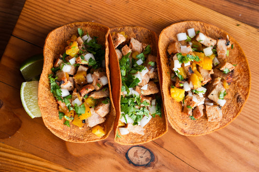 al pastor tacos made over thaan charcoal on the thaan grill