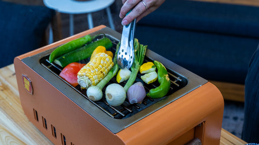 Grilling vegetables on the Thaan Grill over live fire